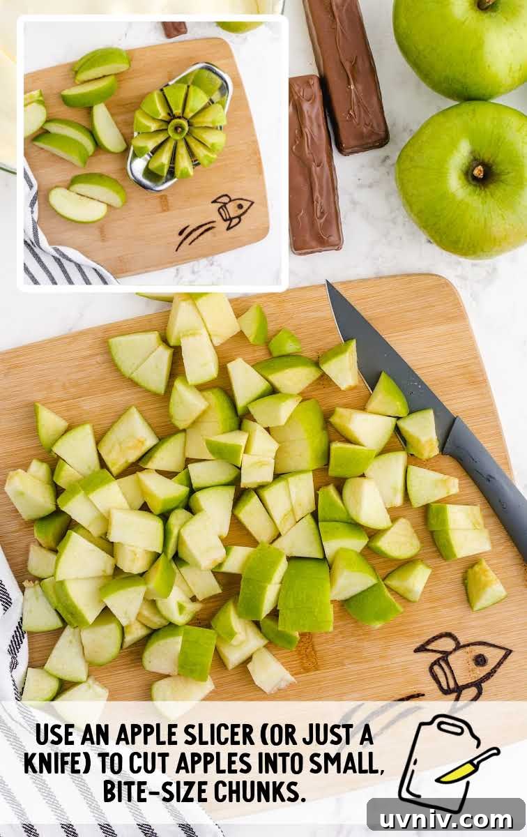 Snickers Salad Recipe: Creamy Dessert Salad with Chocolate & Peanut Butter 5 apples being sliced on a wooden board