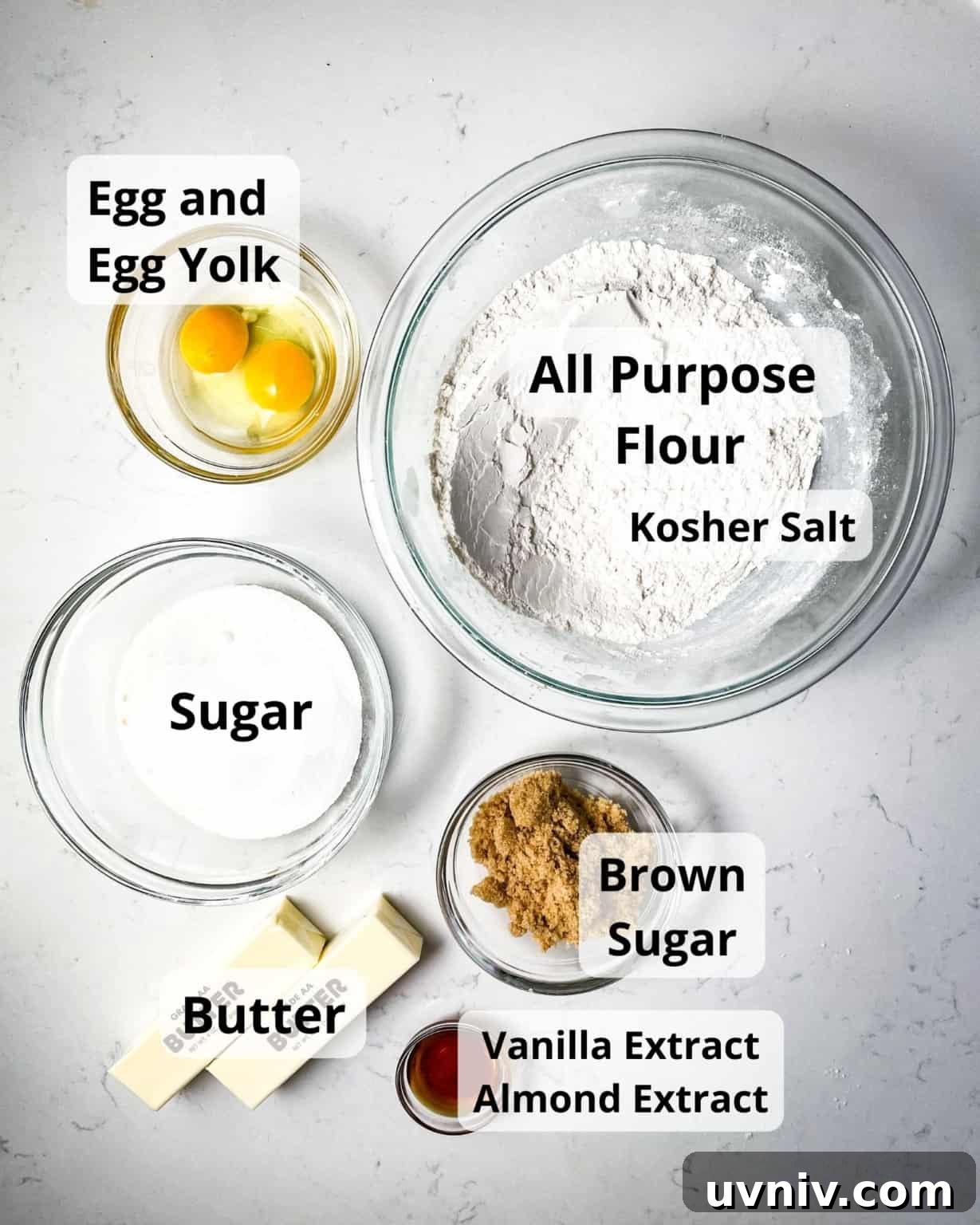 How to Make Perfect Snowflake Sugar Cookies for Winter Parties 4 ingredients to make snowflake cookies - flour, salt, egg, egg yolk, sugar, brown sugar, vanilla extract, almond extract, and butter.