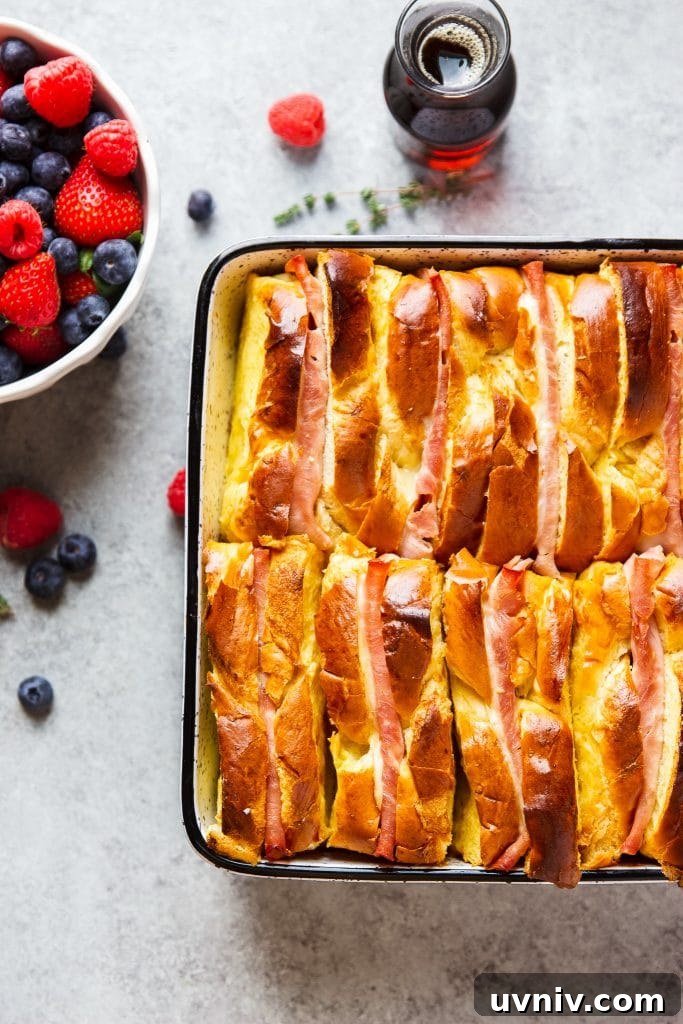 Ham and Cheese Breakfast Casserole Recipe for Brunch and Meal Prep 2 Ham and Cheese Breakfast Casserole served with warm syrup and a side of blueberries, strawberries and raspberries.
