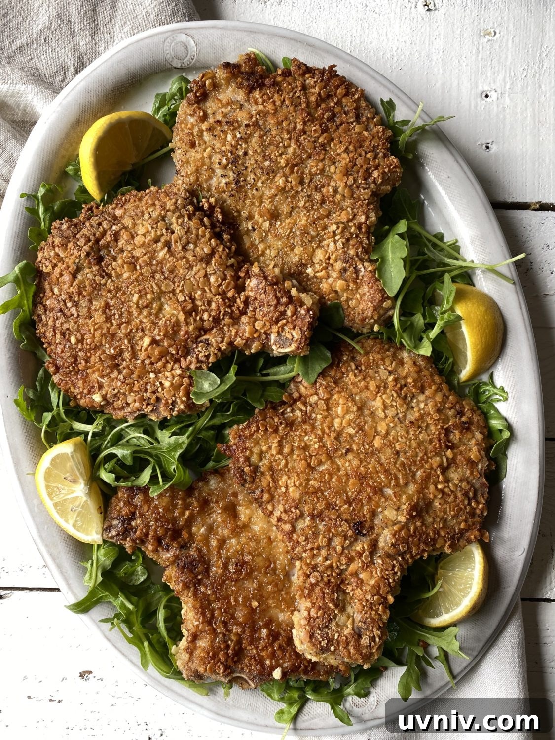 Crispy Gluten-Free Pork Milanese Recipe 2 pork milanese on a platter