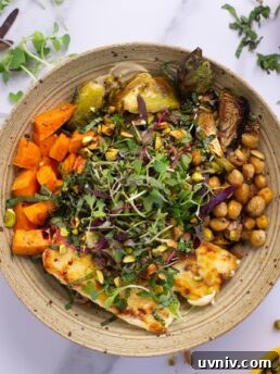 Bowl with creamy cashew sauce, orzo, fried feta, roasted brussels sprouts and chickpeas and sweet potatoes