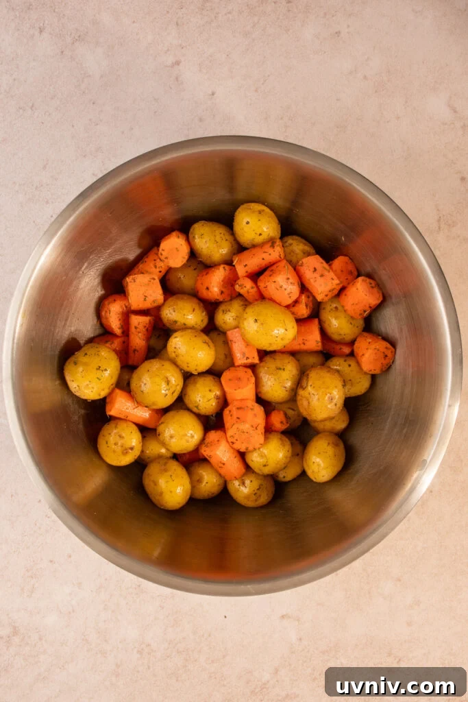 Slow Cooker Chicken Legs with Crispy Potatoes Recipe 5 Prepping the carrots and baby potatoes in a mixing bowl with italian seasoning.