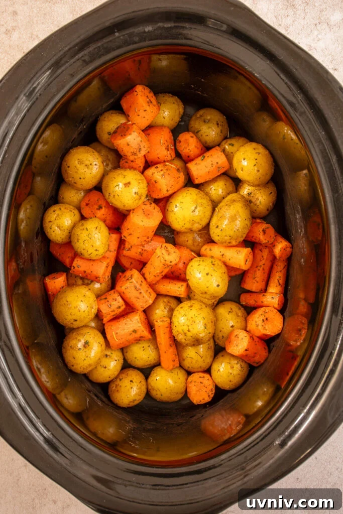 Slow Cooker Chicken Legs with Crispy Potatoes Recipe 6 Seasoned carrots and baby potatoes added to the crockpot.