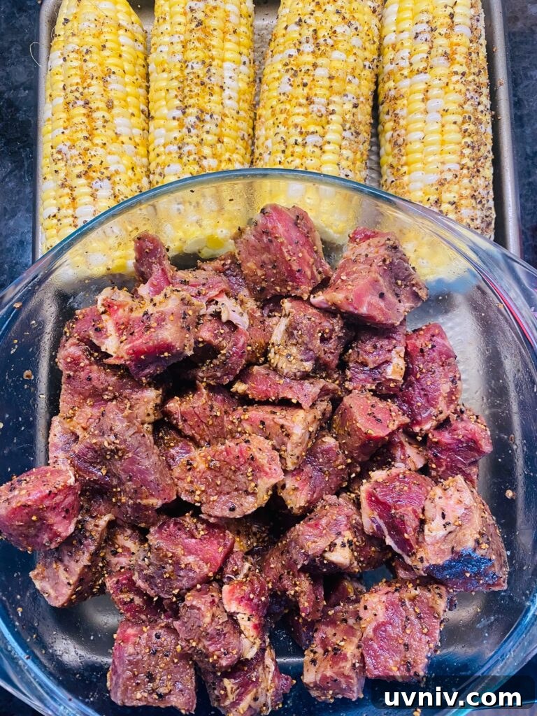 Blackstone Grilled Chopped Steak Salad Recipe 4 seasoned steak and corn on a tray before cooking