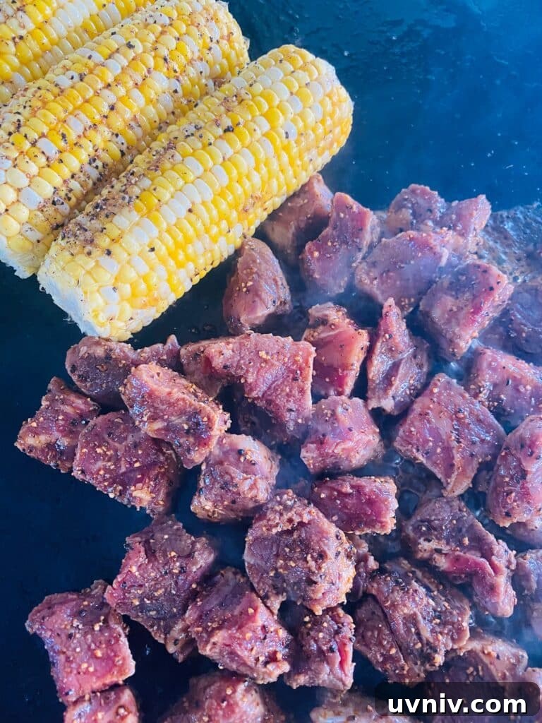 Blackstone Grilled Chopped Steak Salad Recipe 6 steak and corn on the griddle before cooking