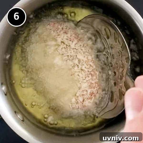 Frying a menchi pattie in oil