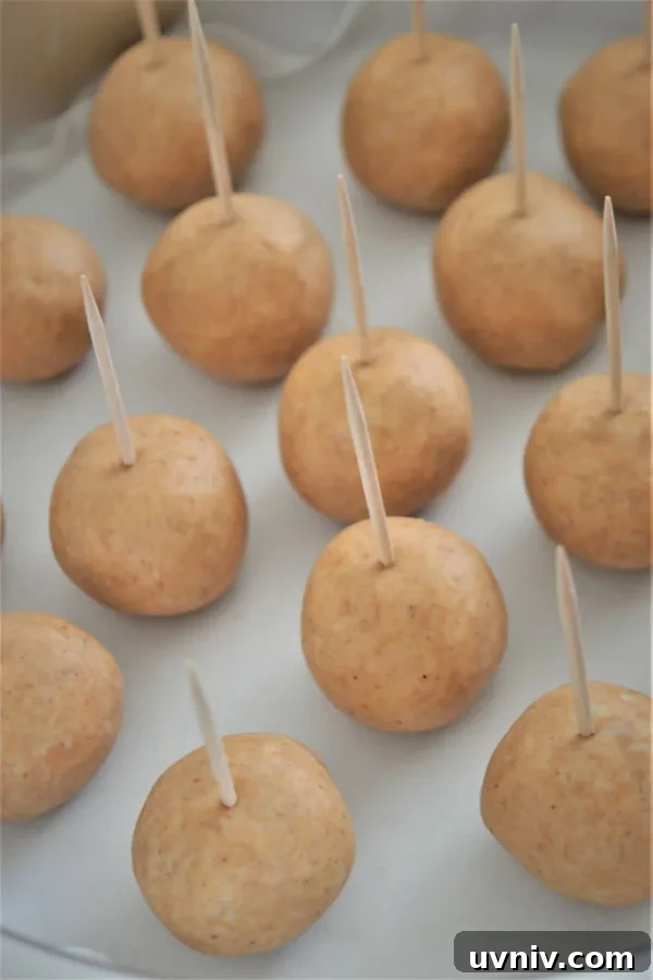Homemade Buckeyes: Chocolate-Covered Peanut Butter Balls Recipe 4 peanut butter balls with toothpick in the top