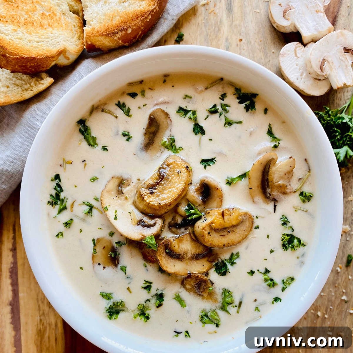 Creamy Wild Mushroom Soup Recipe — Comforting Homemade Soup 6 healthy mushroom soup in white bowl next to crusty bread