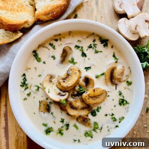 Creamy Wild Mushroom Soup Recipe — Comforting Homemade Soup 7 healthy mushroom soup in white bowl next to crusty bread