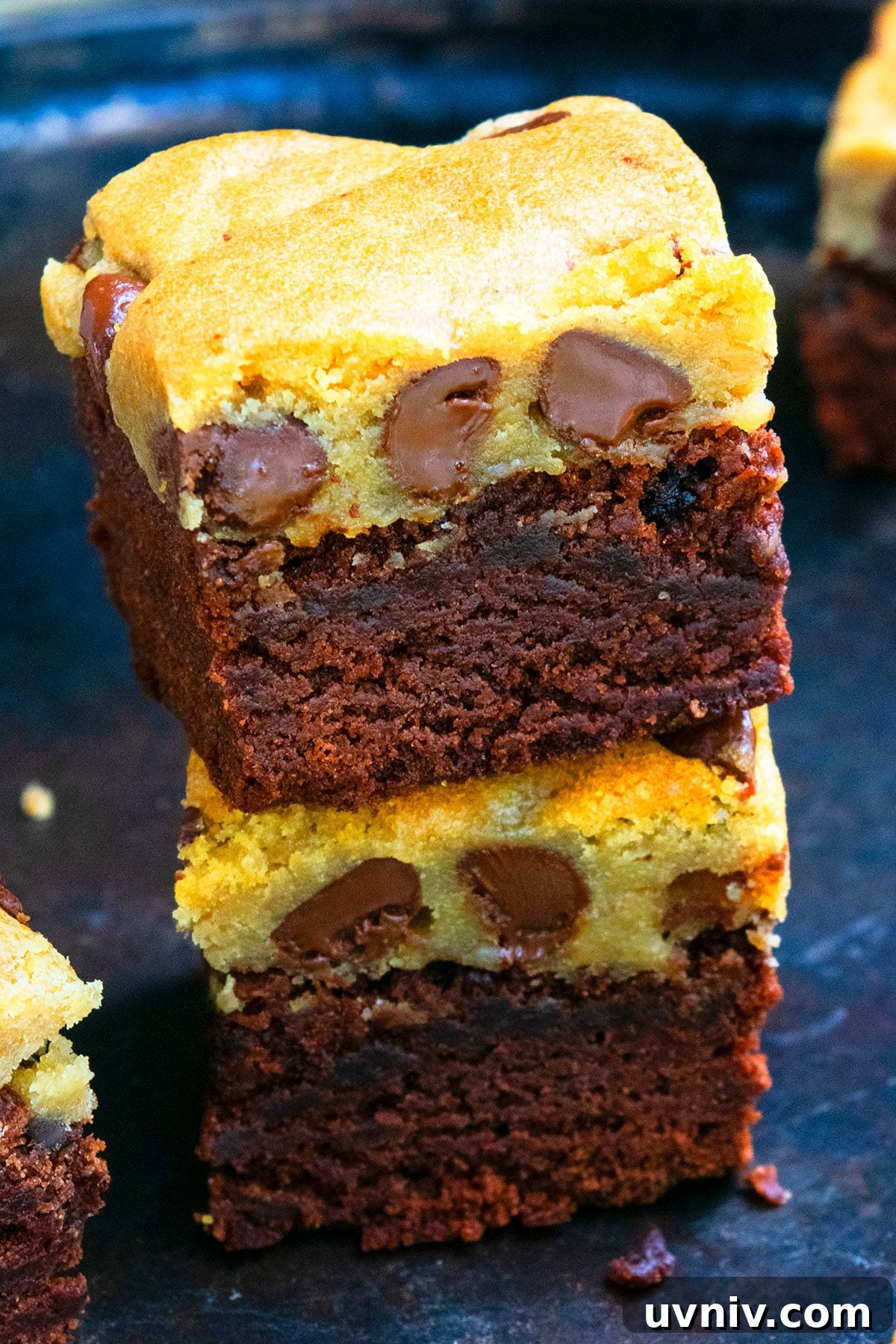 Brookie Recipe Using Brownie Mix: Chewy Cookie-Brownie Bars 12 Stack of Homemade Loaded Bars on Dark Metal Tray.