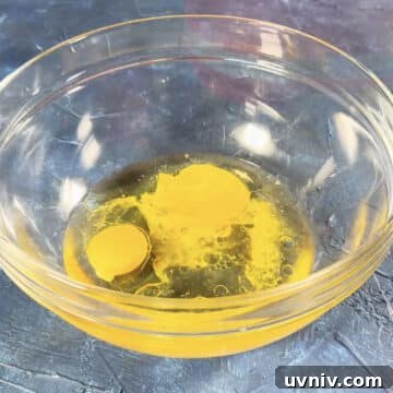 Brookie Recipe Using Brownie Mix: Chewy Cookie-Brownie Bars 4 Eggs, oil and water in a glass bowl.