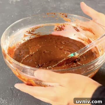 Brookie Recipe Using Brownie Mix: Chewy Cookie-Brownie Bars 7 Brownie batter with spatula in glass bowl.