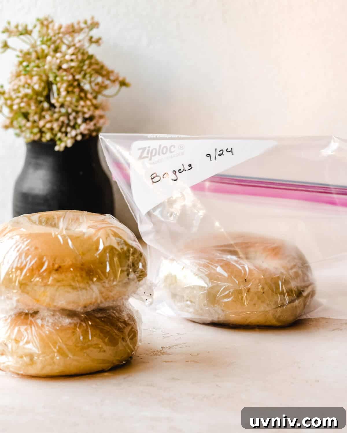 How Long Do Bagels Stay Fresh in the Fridge? 7 Bagels covered in plastic wrap sitting in front of a ziploc bag.