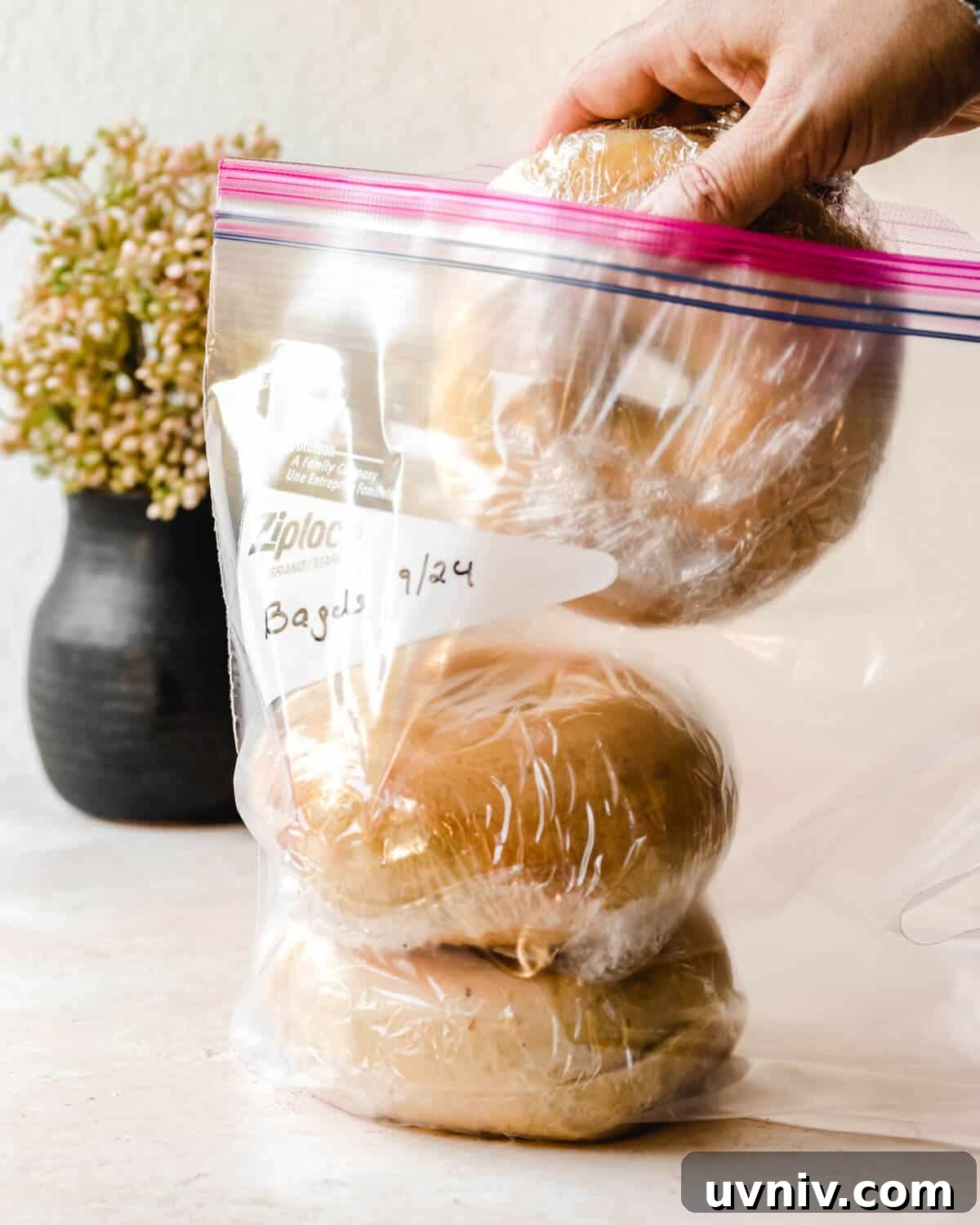 How Long Do Bagels Stay Fresh in the Fridge? 8 Hand adding a bagel in plastic wrap to the air tight plastic bag.