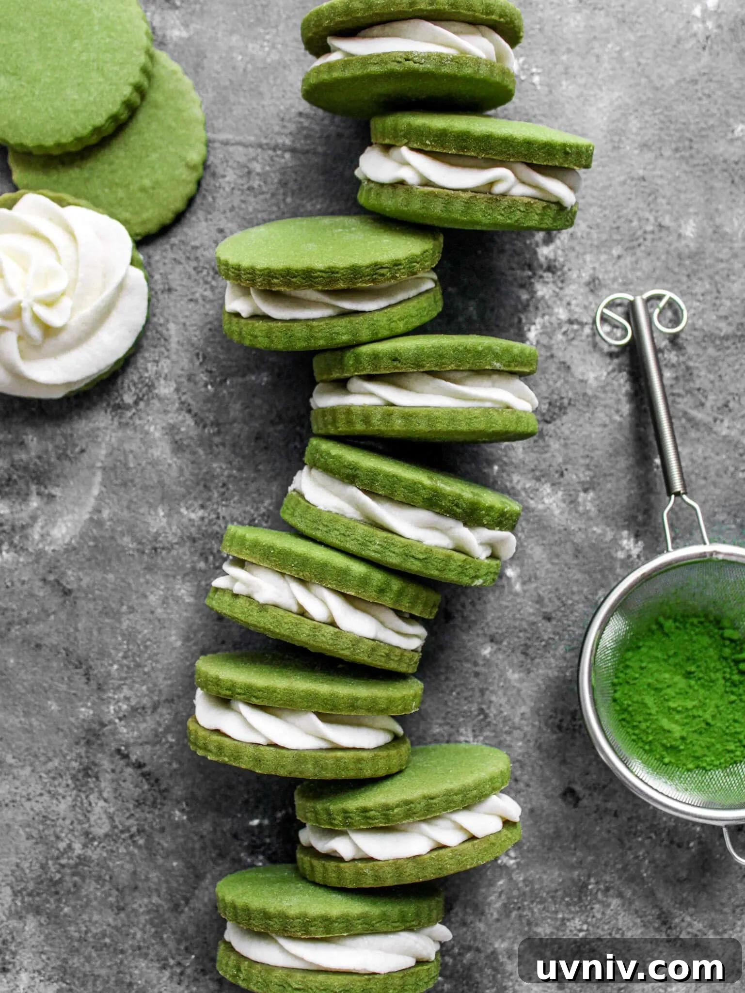 Matcha Cream Sandwich Cookies: Soft Green Tea Cookie Recipe 10 filled matcha sandwich cookies lined up on sides overhead image