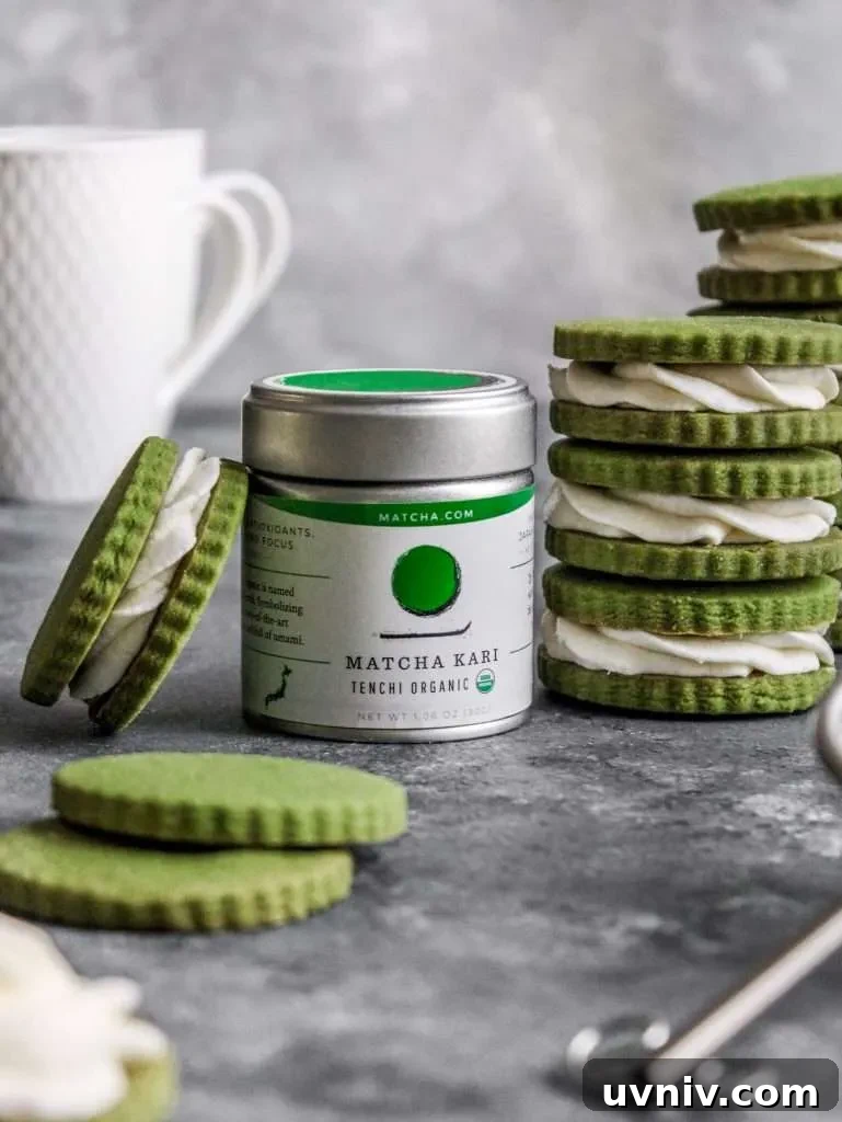 Matcha Cream Sandwich Cookies: Soft Green Tea Cookie Recipe 7 filled matcha sandwich cookies stacked around tin of matcha powder (2)