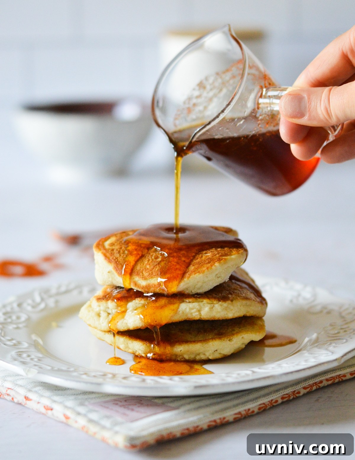 Spicy Maple Syrup Recipe: Sweet Heat for Breakfast & Glaze 2 pouring spicy maple syrup onto pancakes.