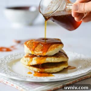 Spicy Maple Syrup Recipe: Sweet Heat for Breakfast & Glaze 8 pouring spicy maple syrup on pancakes.