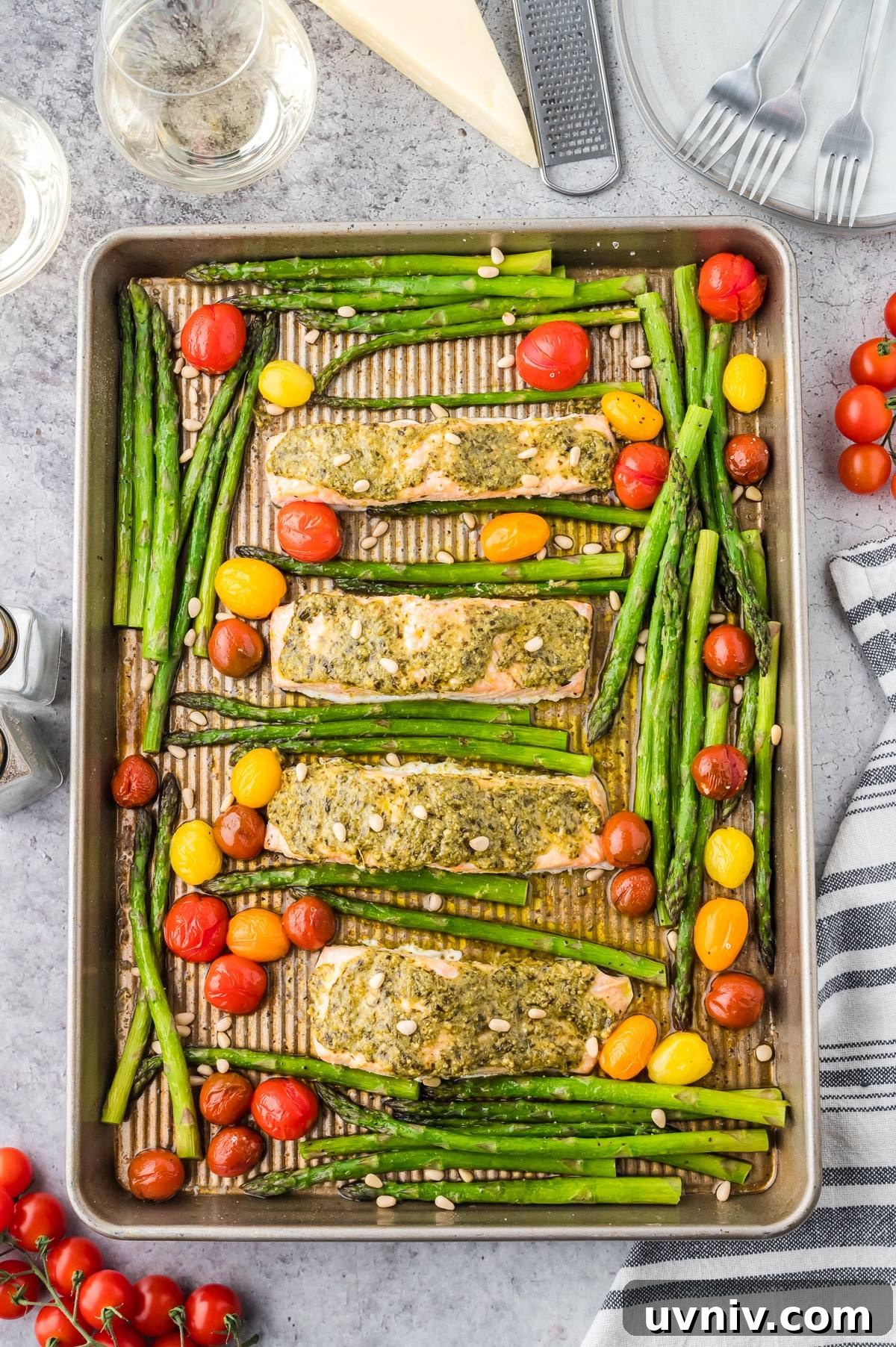 One-Pan Salmon and Roasted Asparagus Recipe 4 Sheet pan with four pesto-topped salmon fillets, asparagus, and cherry tomatoes, ready to serve.