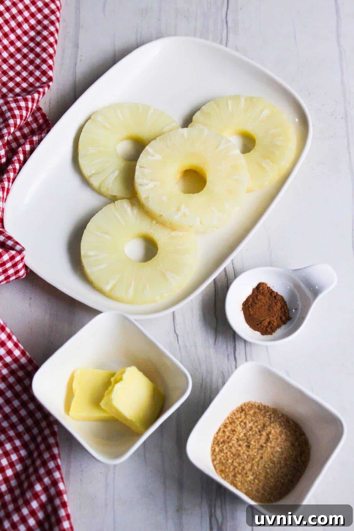 Crispy Caramelized Pineapple in the Air Fryer 3 A plate with pineapple slices, cinnamon, brown sugar and butter.