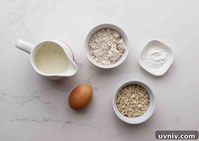 Single-Serve Oatmeal Protein Pancakes Recipe 3 Oats, baking powder, egg, and milk on a table.