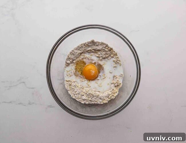 Single-Serve Oatmeal Protein Pancakes Recipe 5 Oat flour and an egg in a bowl.