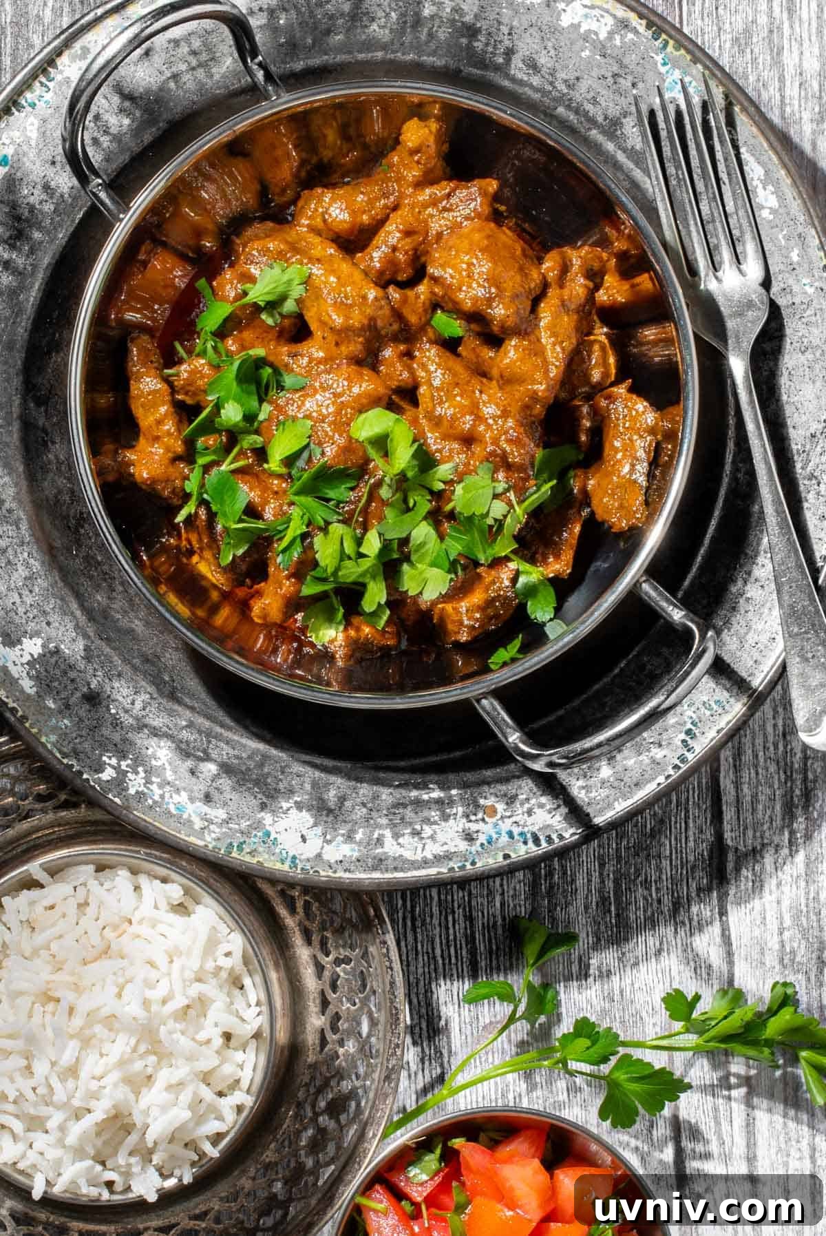 Coconut Milk Beef Curry Recipe: Rich, Creamy, Slow-Simmered 2 Aromatic beef curry with coconut milk in a balti bowl with a side of rice.