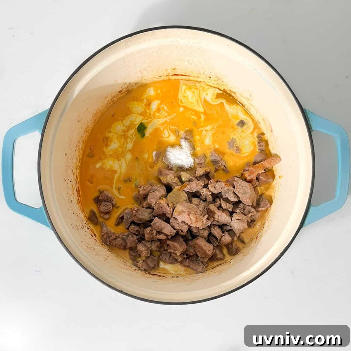 Coconut Milk Beef Curry Recipe: Rich, Creamy, Slow-Simmered 12 Adding the beef back into the pot for the beef curry with coconut milk.