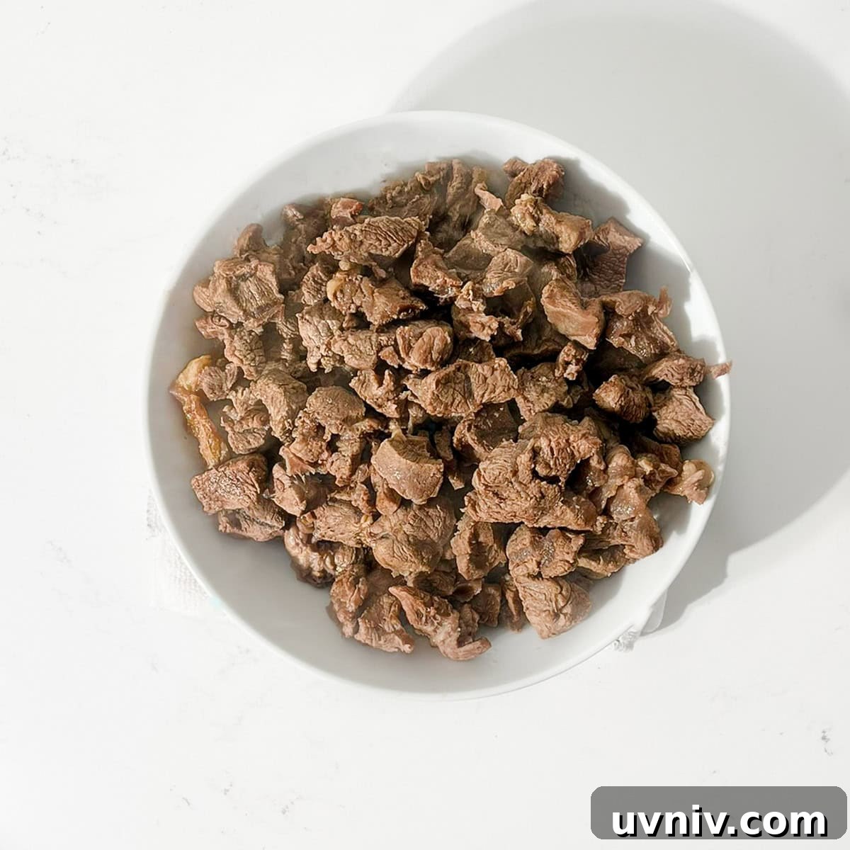Coconut Milk Beef Curry Recipe: Rich, Creamy, Slow-Simmered 6 Browned meat in a white bowl.