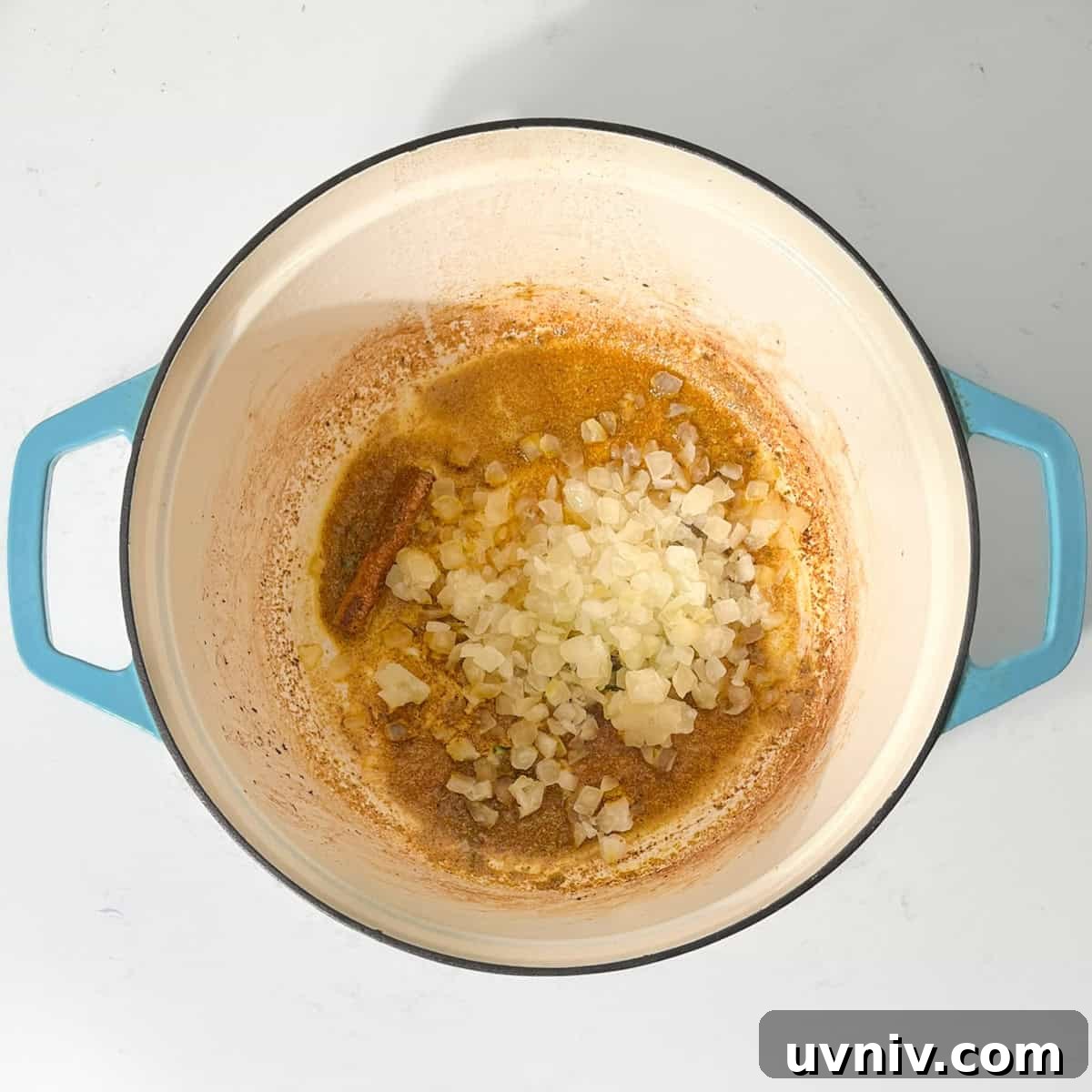 Coconut Milk Beef Curry Recipe: Rich, Creamy, Slow-Simmered 8 Adding onions to the hot oil for the beef curry with coconut milk.
