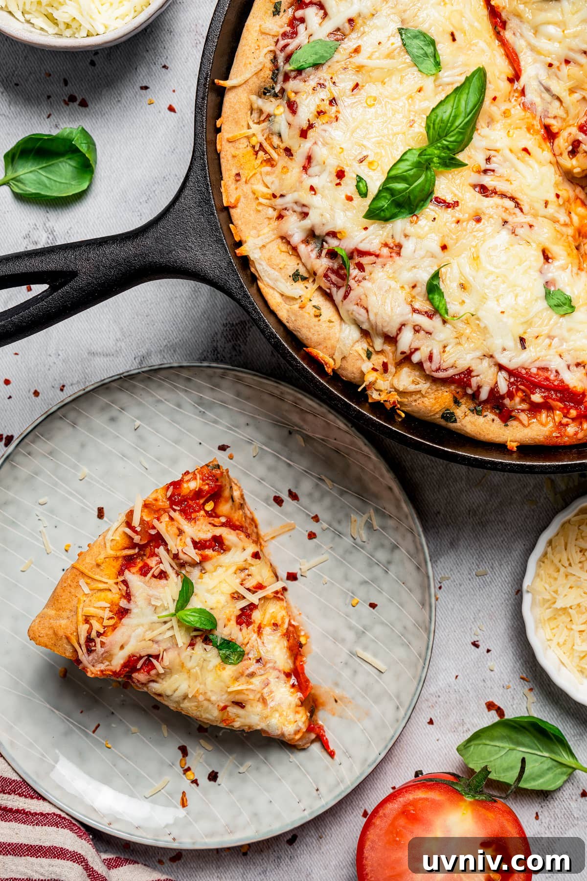 This deep dish pizza recipe with homemade herbed crust, tomatoes, and lots of melty cheese will bring Pizza Night to your kitchen each week. Slice of deep dish pizza served on a plate.