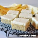 a couple of banana bars on a wire rack with a bunch of bananas in the background
