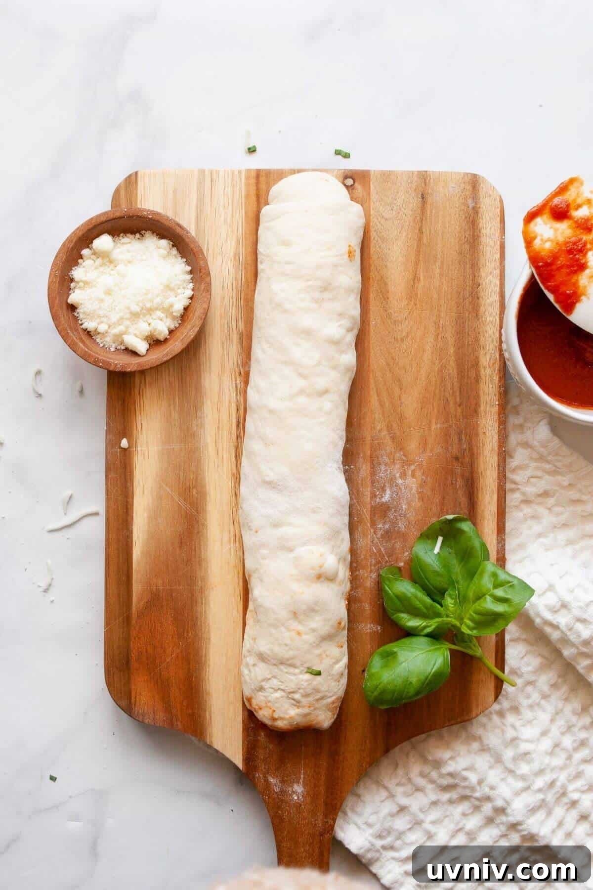 Crispy Air Fryer Pizza Rolls You Can Make at Home 7 Rolling up pizza dough tightly with mozzarella, marinara, and basil to make homemade air fryer pizza rolls.