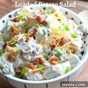 Creamy Loaded Potato Salad Made in the Instant Pot 14 loaded baked potato salad garnished with bacon, cheddar, scallions in a white bowl