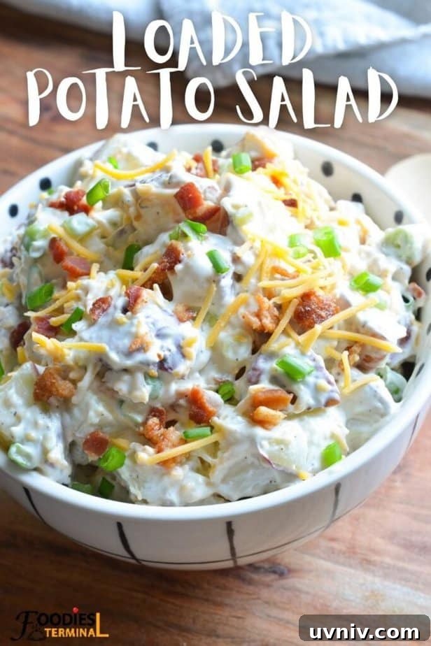 Creamy Loaded Potato Salad Made in the Instant Pot 9 fully loaded red potato salad in a white bowl garnished with crispy bacon, green onion & shredded cheddar cheese.