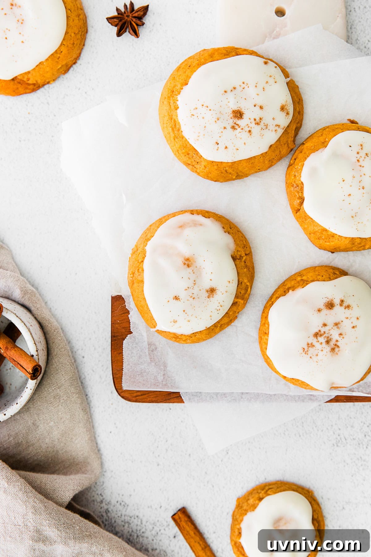 Soft Pumpkin Cookie Recipe for Moist, Fall-Ready Treats 2 Soft Pumpkin Cookies topped with frosting and cinnamon.
