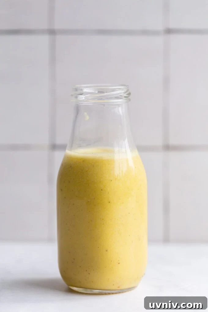 creamy garlic dressing in a small glass jar