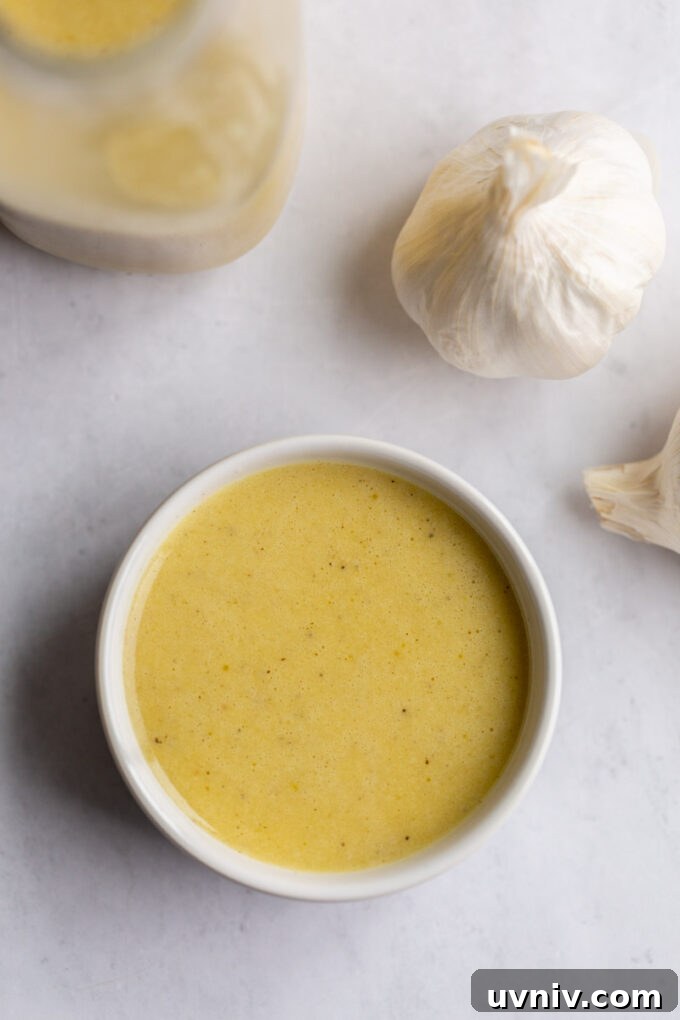 small white bowl of creamy garlic dressing