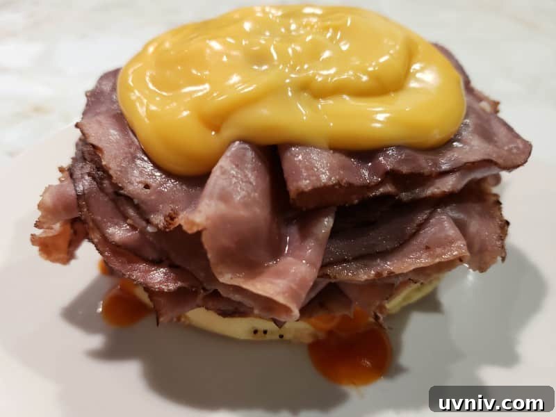 Make-Ahead Arby’s-Style Beef & Cheddar Sandwich Recipe 5 a bottom half of a beef and cheddar sandwich