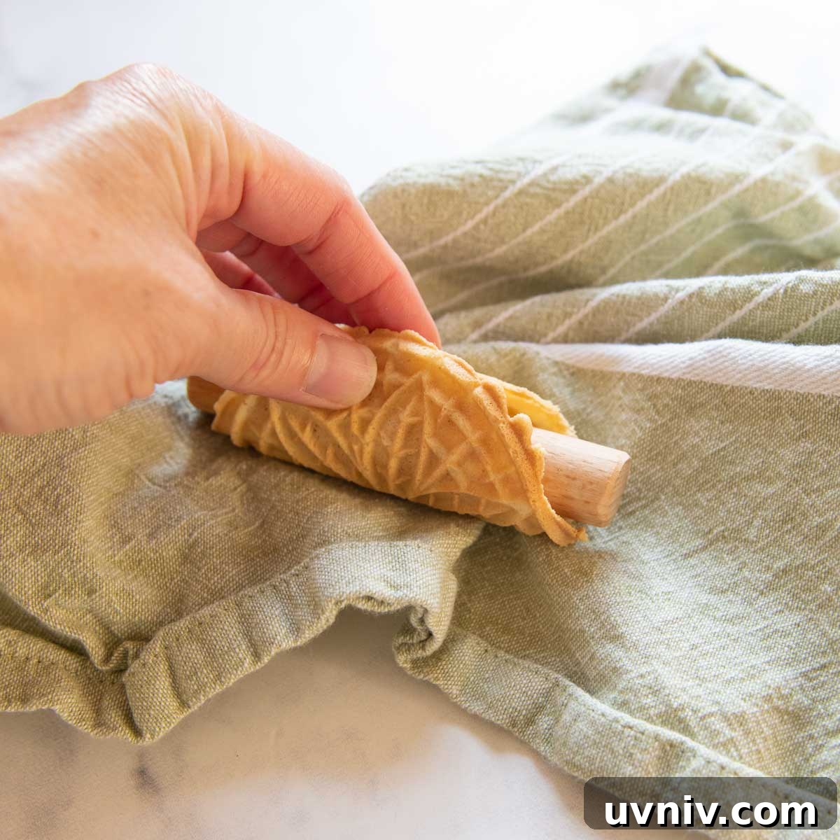 a small pizzelle wrapped around a rod.