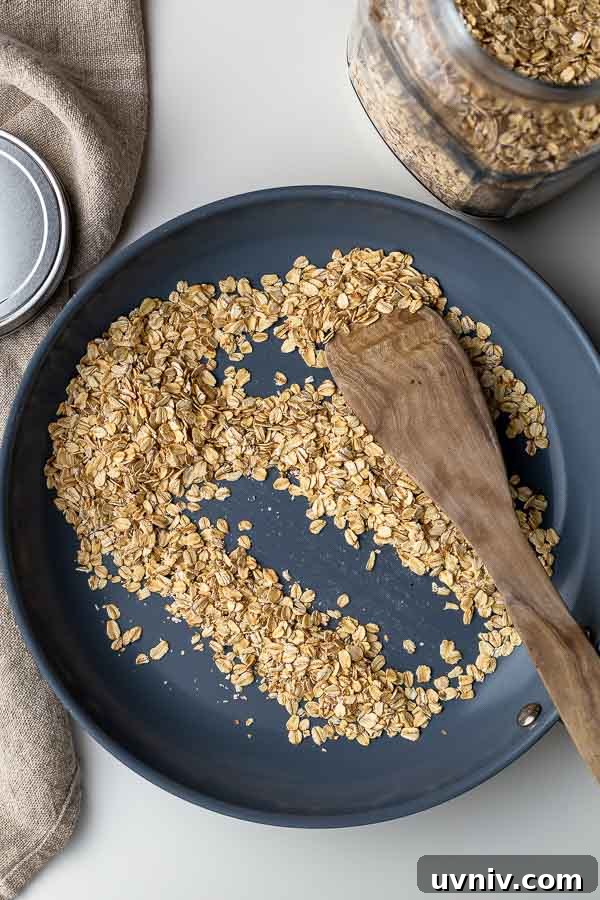 Crispy Oven-Baked Granola Without Oil: Crunchy Homemade Recipe 3 toasting rolled oats in a skillet