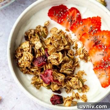Crispy Oven-Baked Granola Without Oil: Crunchy Homemade Recipe 8 Granola and sliced strawberries over yogurt in a white bowl