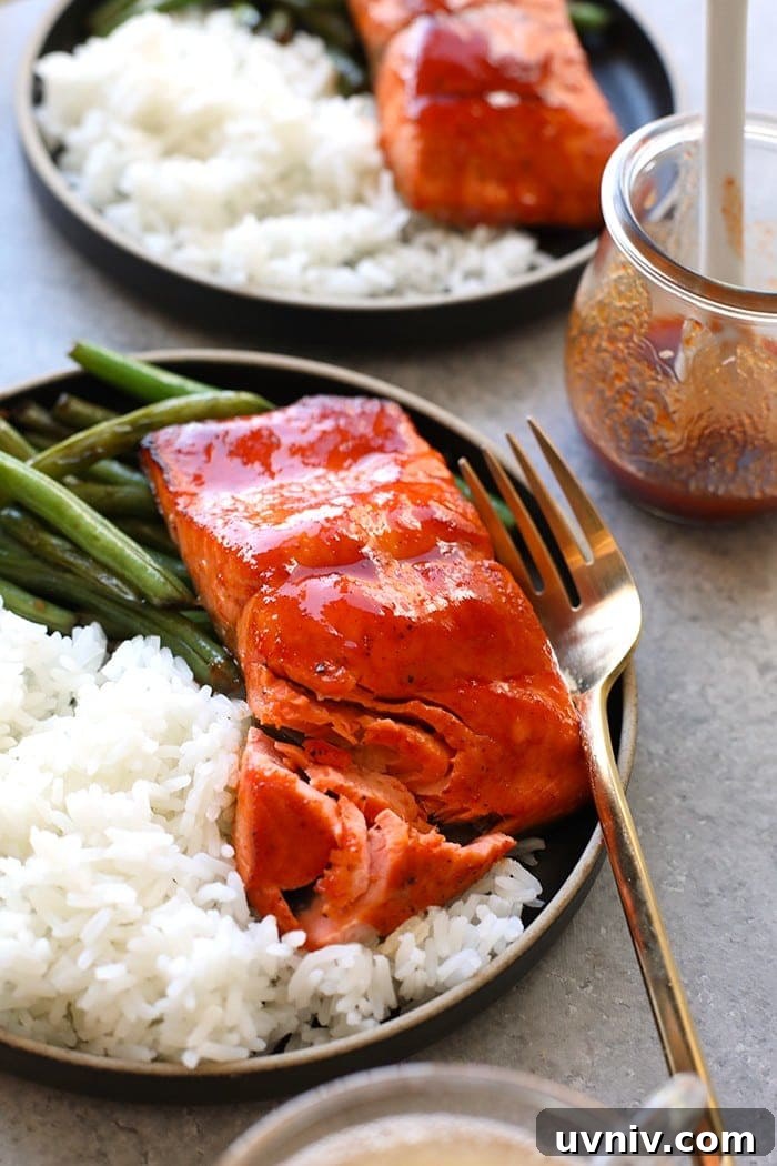 honey sriracha salmon on plate with white rice and green beans