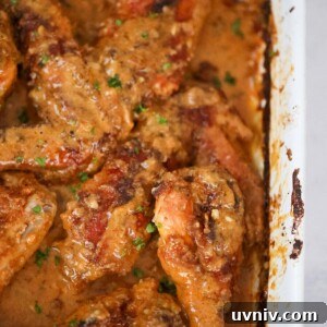 Smothered Turkey Wings Recipe: Tender, Flavorful Comfort Meal 2 Smothered turkey wings and legs in a baking dish up close.