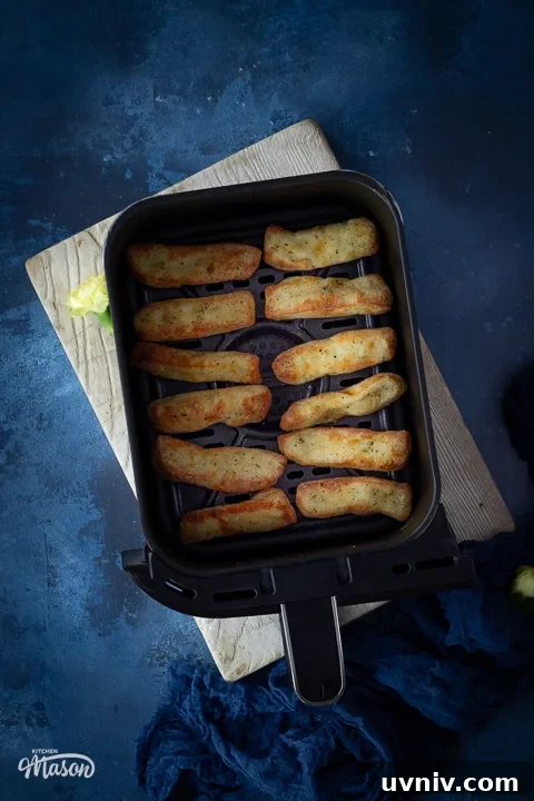 Crispy Air Fryer Halloumi Fries Recipe (UK) 6 Halloumi cheese sticks in an air fryer drawer
