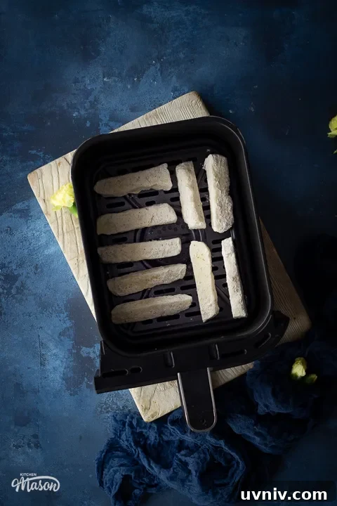 Crispy Air Fryer Halloumi Fries Recipe (UK) 11 Floured halloumi sticks in an air fryer drawer
