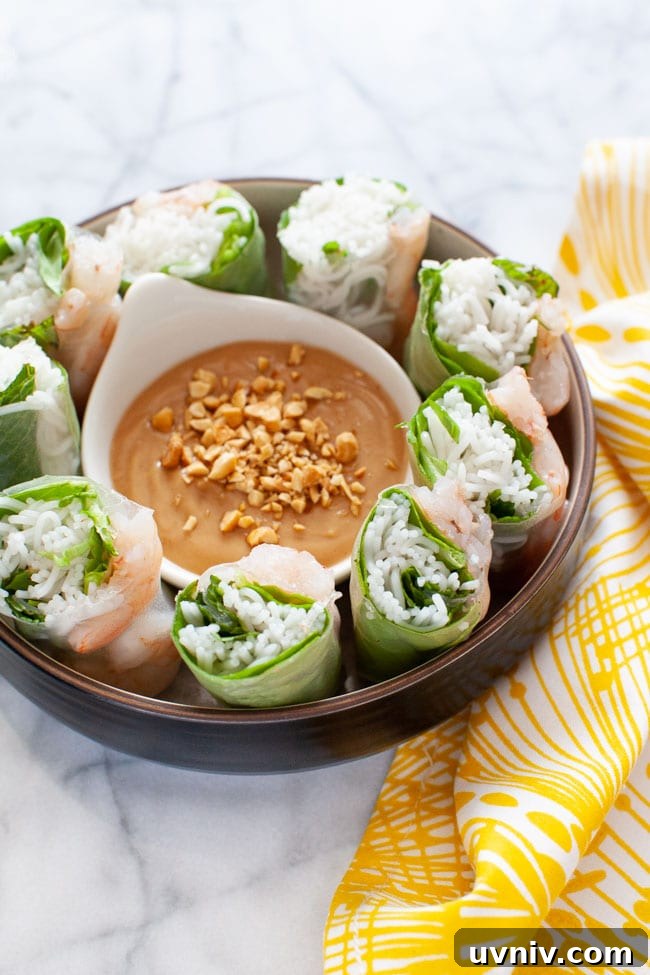 Fresh Vietnamese Spring Rolls with Creamy Peanut Dipping Sauce 6 Vietnamese Spring Rolls cut up in a bowl with peanut dipping sauce on a plate with a napkin in the background