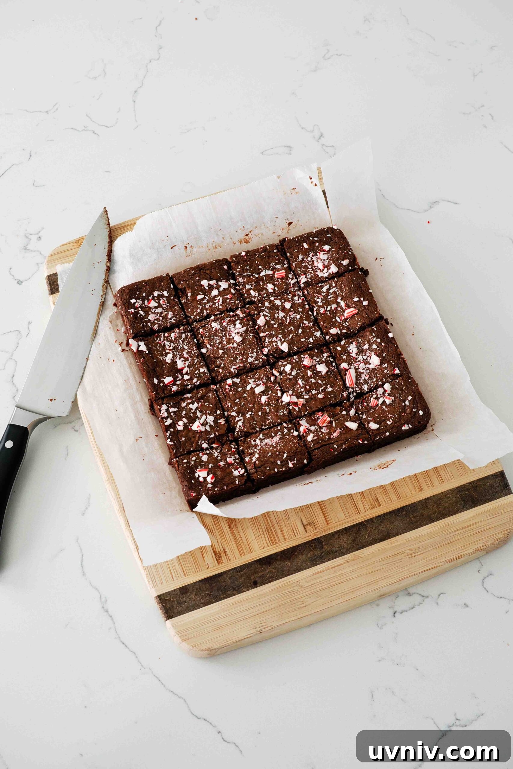 Decadent Peppermint Brownies Recipe for Holiday Baking 15 Freshly sliced peppermint brownies on a cutting board.