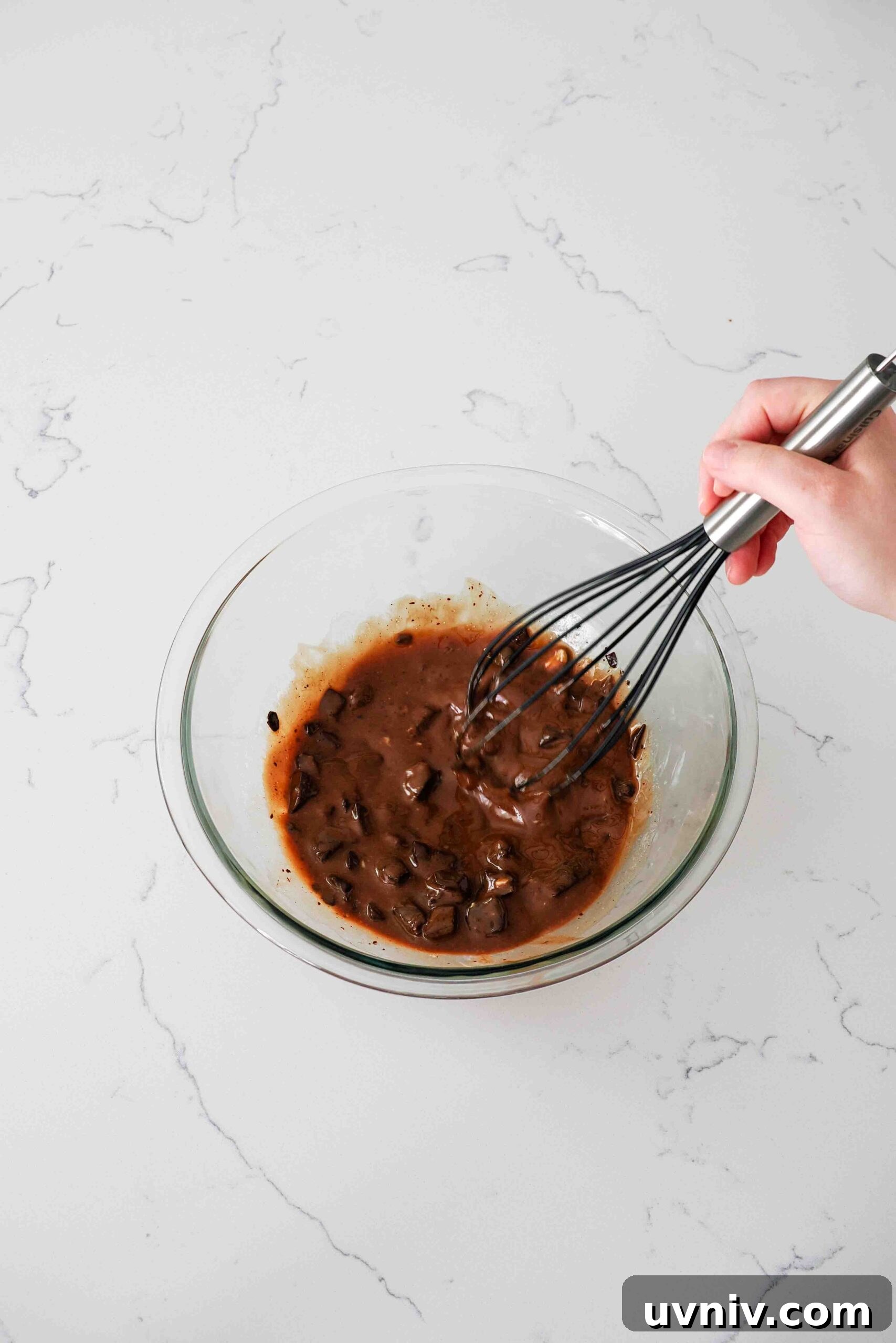 Decadent Peppermint Brownies Recipe for Holiday Baking 6 Lumpy, partially melted chocolate and butter in a glass bowl.