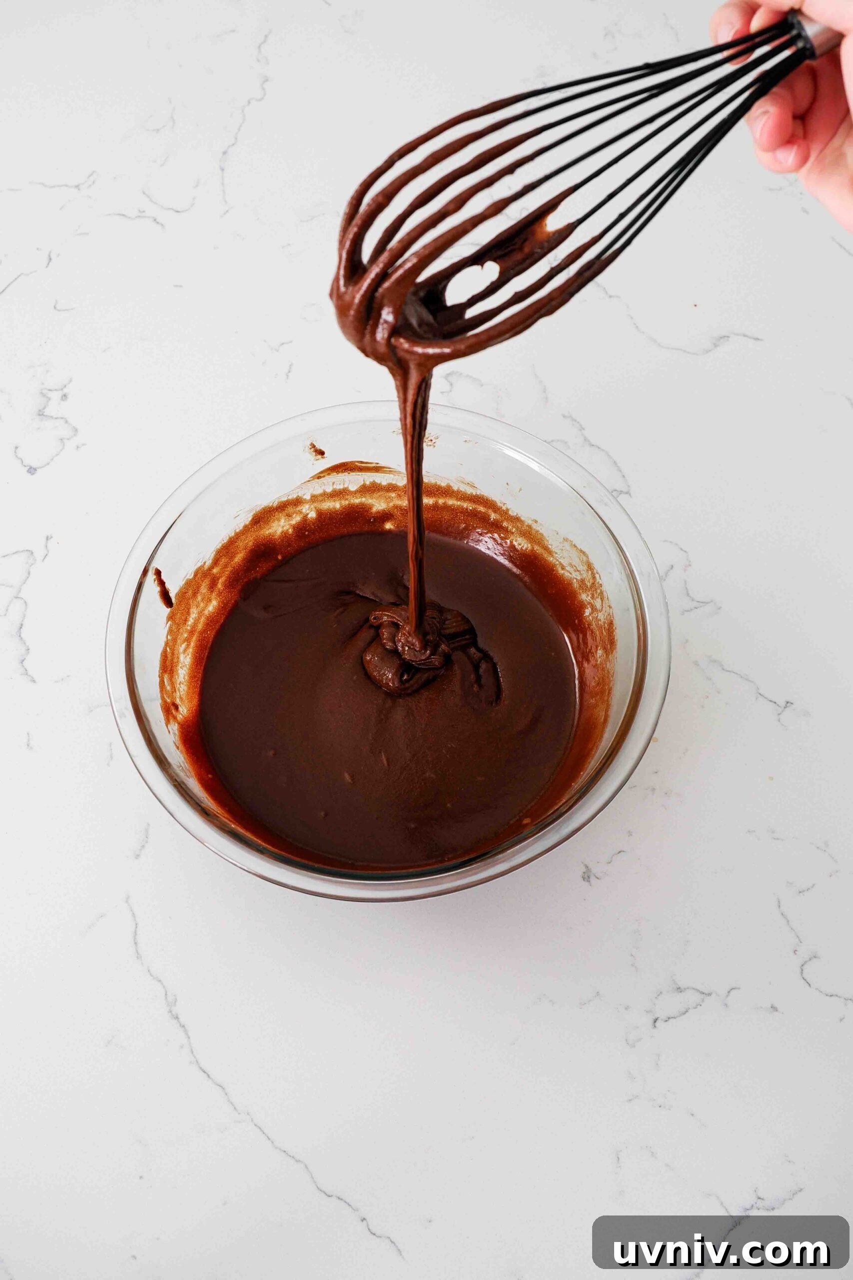 Decadent Peppermint Brownies Recipe for Holiday Baking 8 A whisk holds up brownie batter in the ribbon stage.